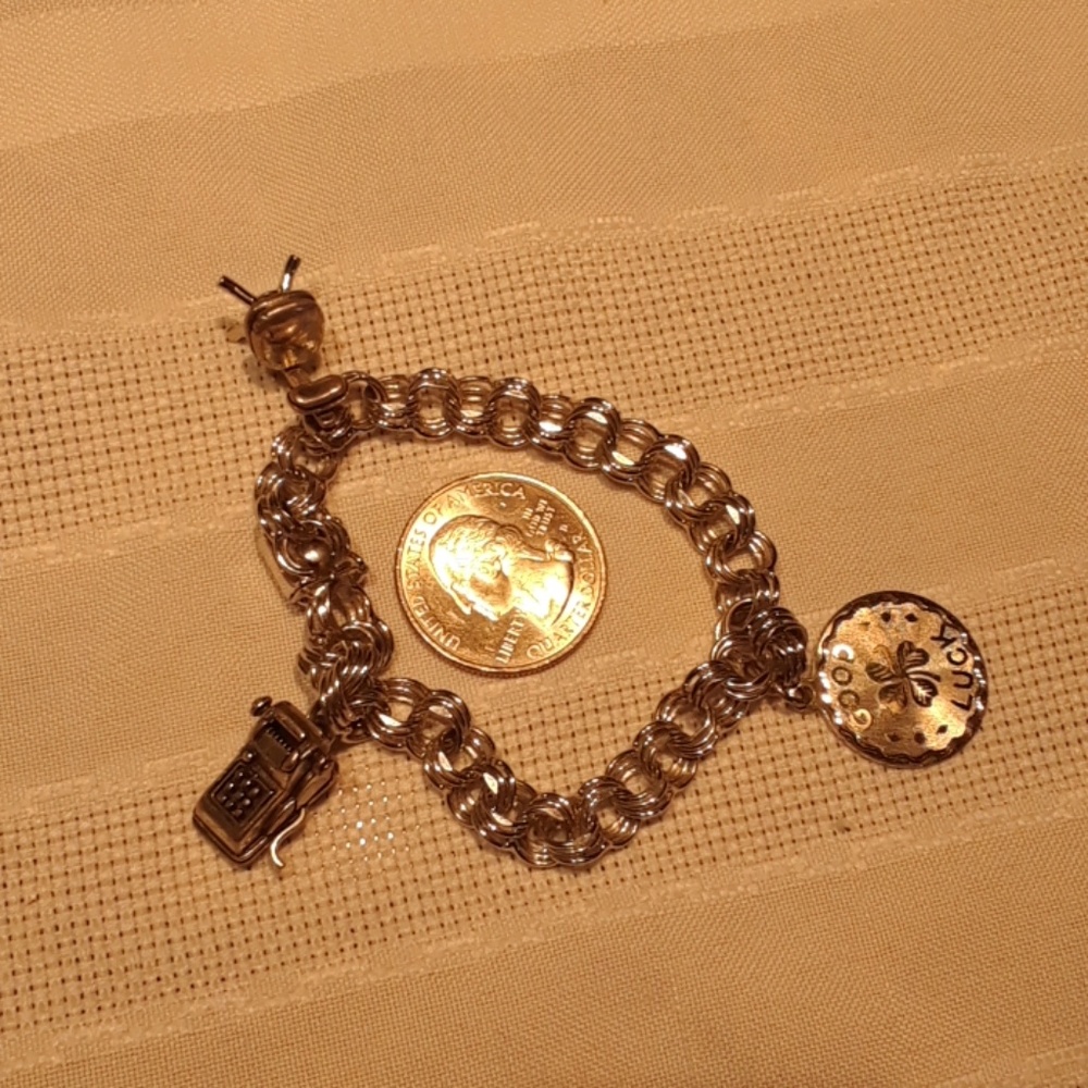 Silver tone charm bracelet.
